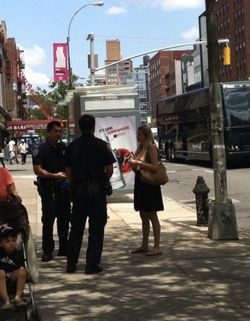 The "Topless Bowery Woman" being questioned by police near Prince Street